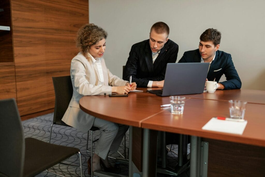 Ifza Free zone, a group of people sitting at a table looking at a laptop